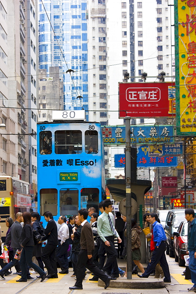 Pedestrians and tram in old Chinese district, Des Voeux Road, Sheung Wan, Hong Kong Island, China