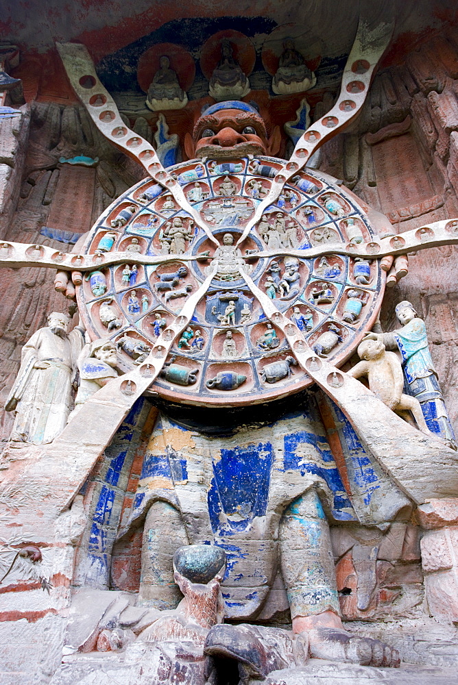 Anicca, God of Destiny holds wheel of life of Buddhist karma, Dazu rock carvings, Mount Baoding, China