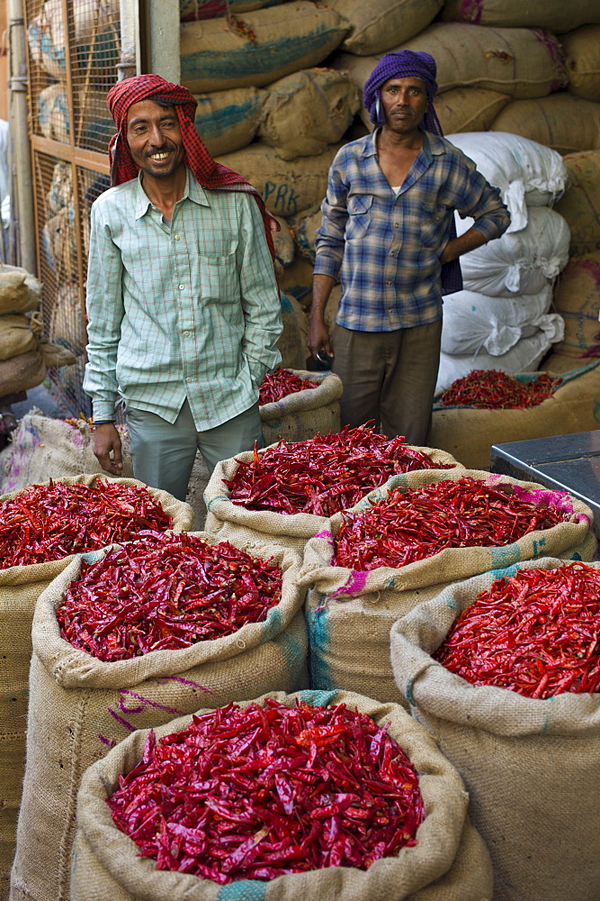 Porters at stall selling red chillies at Khari Baoli spice and dried foods market, Old Delhi, India