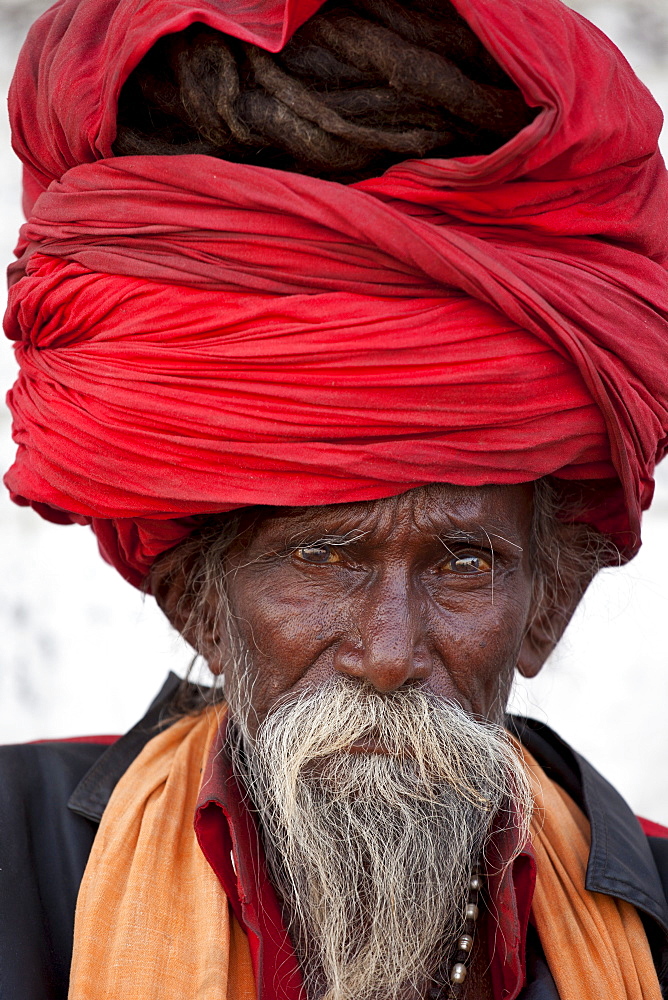 Hindu man pilgrim with long hair in turban at Dashashwamedh Ghat in holy city of Varanasi, Benares, India