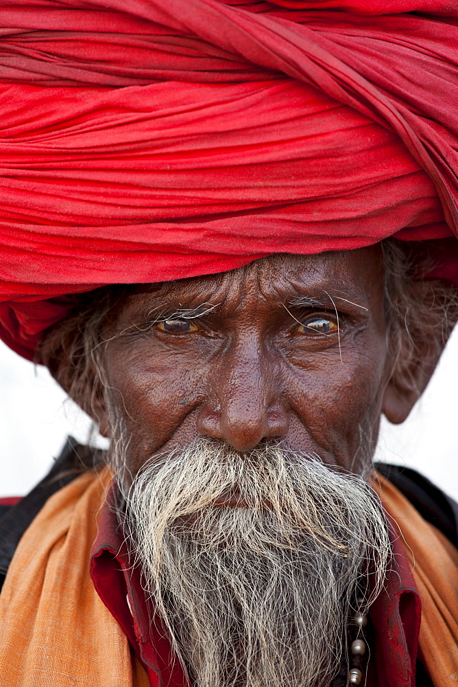 Hindu man pilgrim with long hair in turban at Dashashwamedh Ghat in holy city of Varanasi, Benares, India