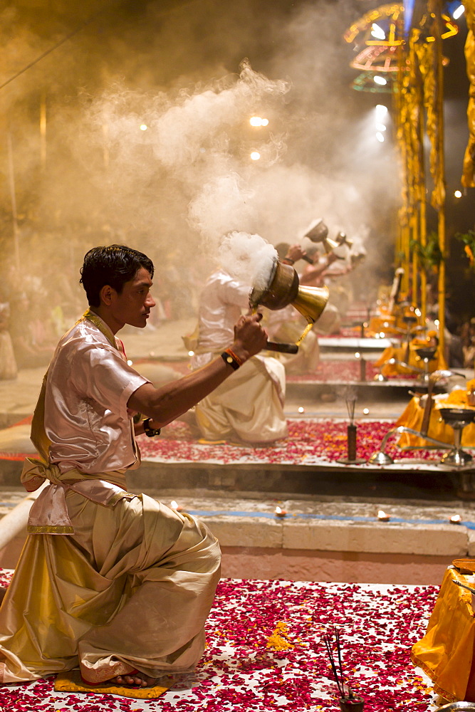 Hindu priests at sundown Aarti Ritual Ceremony of Light during Shivrati Festival in Holy City of Varanasi, Benares, India