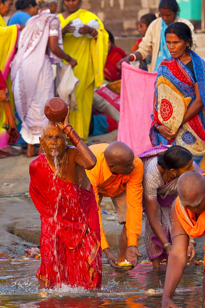 Indian Hindu pilgrims bathing in The Ganges River at Dashashwamedh Ghat in Holy City of Varanasi, Benares, India