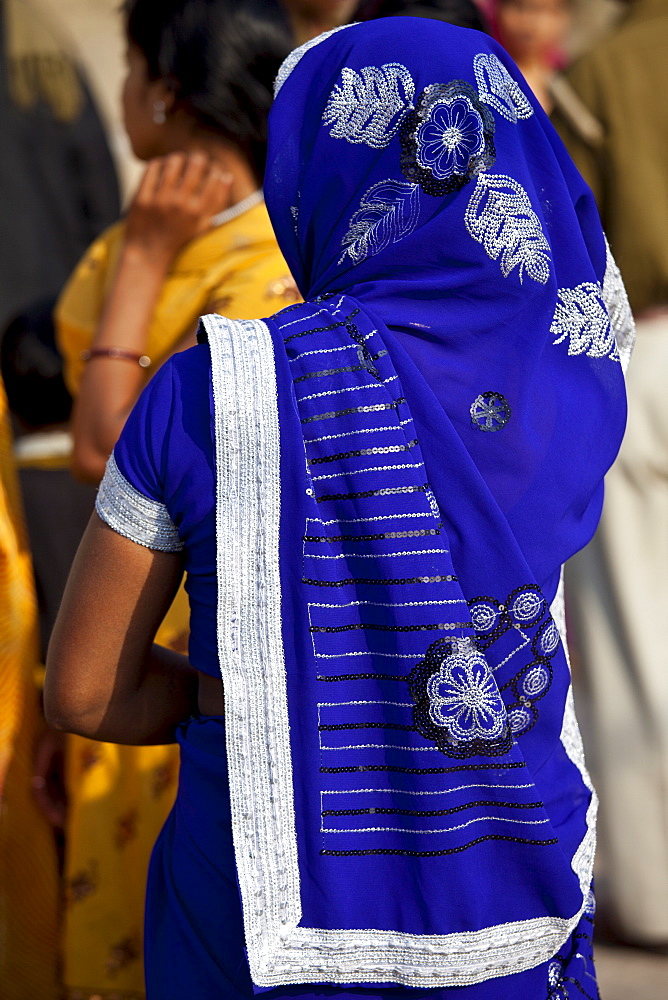 Hindu pilgrim with blue sari at Dashashwamedh Ghat in holy city of Varanasi, Benares, India