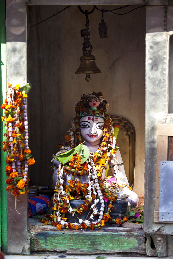 Religious icon on display during Festival of Shivaratri in temple window in the city of Varanasi, Benares, Northern India