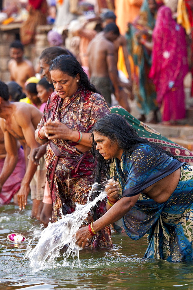 Indian Hindu pilgrim bathing and praying in The Ganges River at Dashashwamedh Ghat in Holy City of Varanasi, India