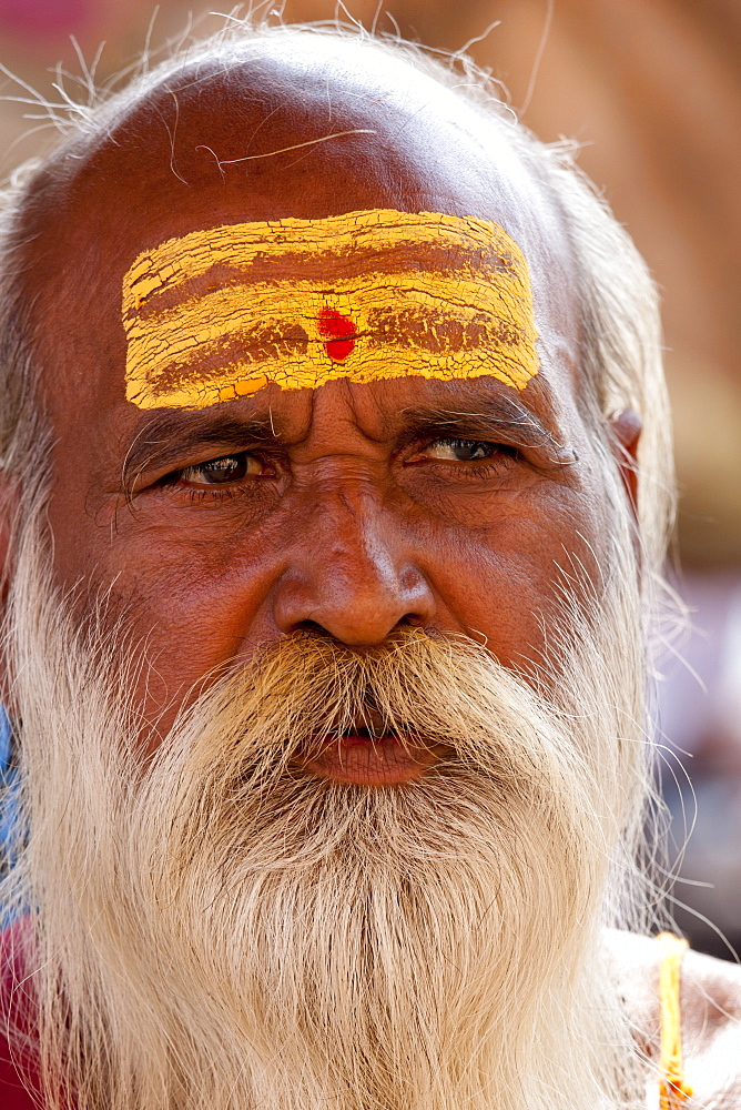 Hindu Sadhu holy man with traditional markings of symbol of Shiva in street in holy city of Varanasi, Benares, Northern India