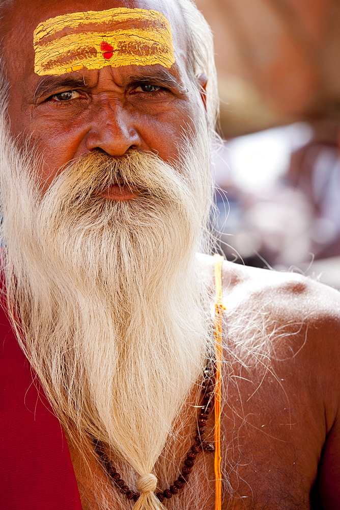 Hindu Sadhu holy man with traditional markings of symbol of Shiva in street in holy city of Varanasi, Benares, Northern India