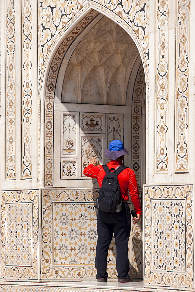 Tourist at Tomb of Etimad Ud Doulah, 17th Century Mughal tomb built 1628, Agra, India