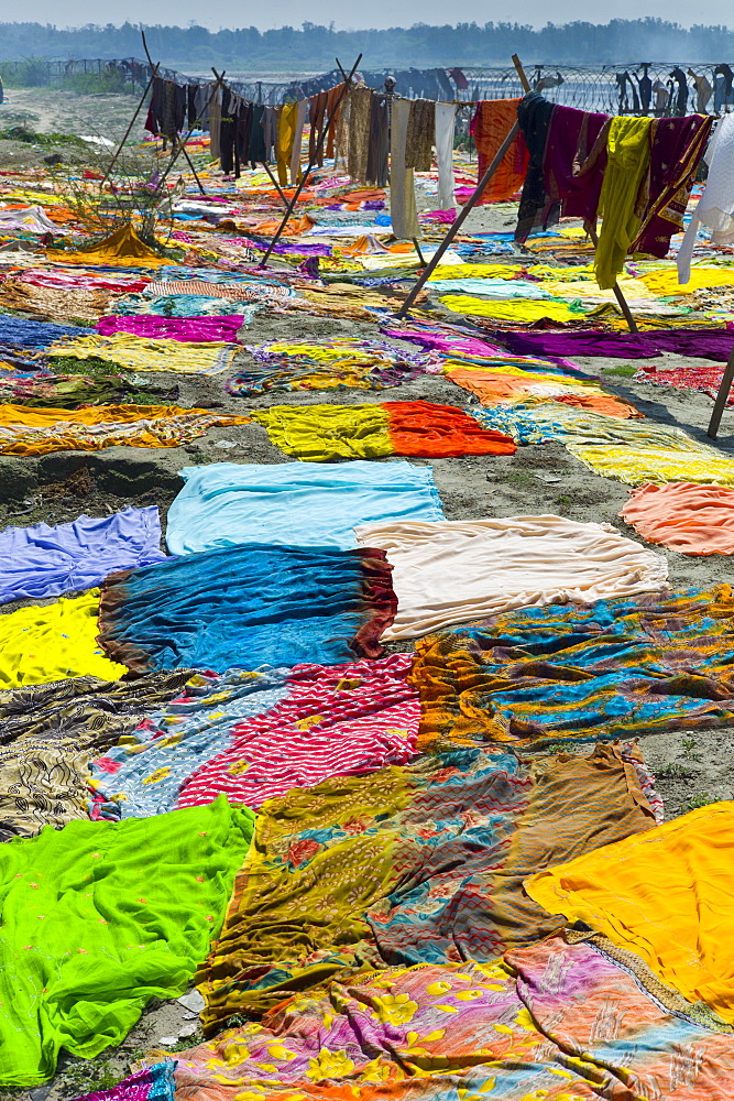 Saris and other laundry drying on the banks of River Yamuna at Agra, India