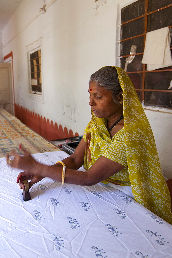 Indian woman die stamping textiles at Dastkar women's craft co-operative, the Ranthambore Artisan Project, in Rajasthan, India