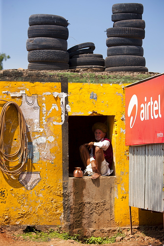 Indian man at his home and business at Ganesh Dham in Sawai Madhopur district in Rajasthan, Northern India