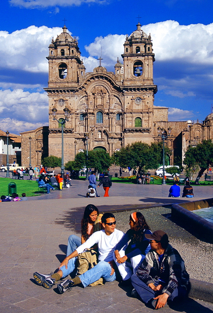 Young people gather in front of La Compania Church, Plaza de Armas  square in Cuzco, the ancient capital of the Inca Empire, Peru, South America