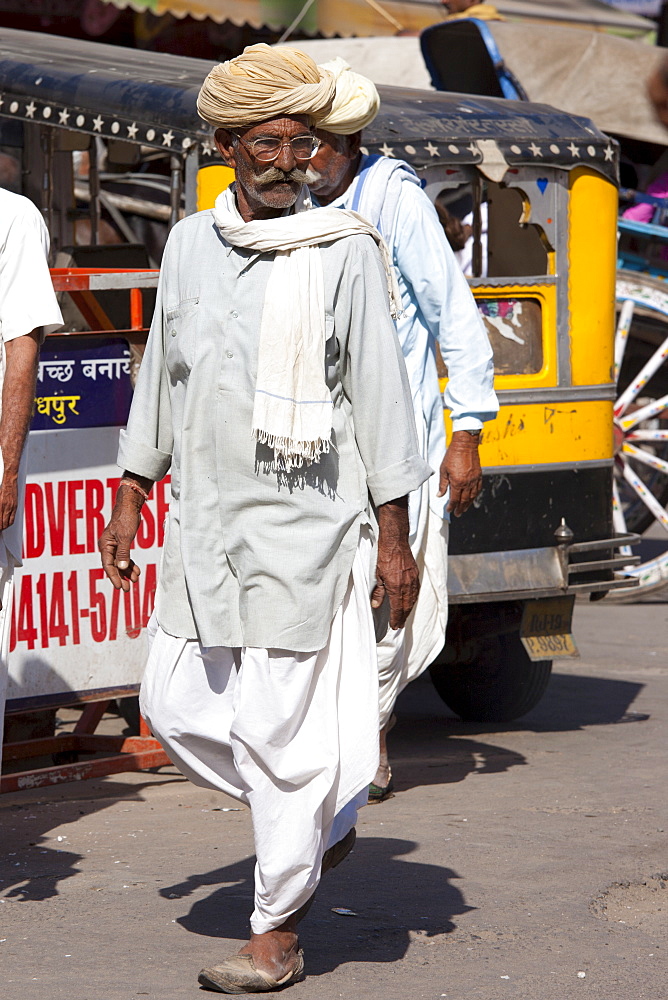 Indian man in traditional dhoti trousers and turban at Sardar Market at Girdikot, Jodhpur, Rajasthan, Northern India