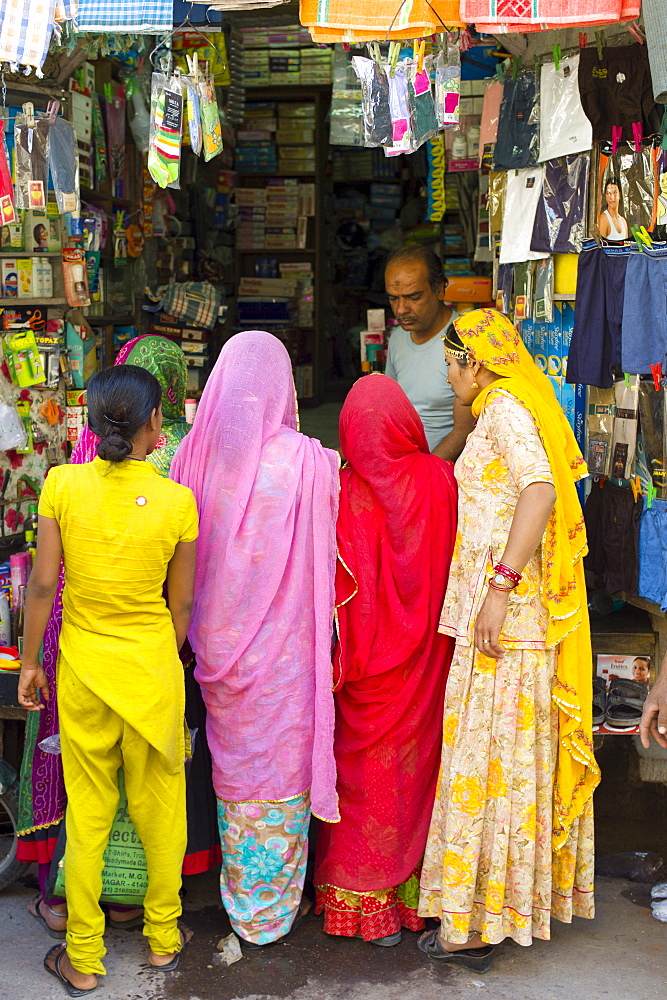 Indian women shopping, street scene at Tambaku Bazar in Jodhpur Old Town, Rajasthan, Northern India