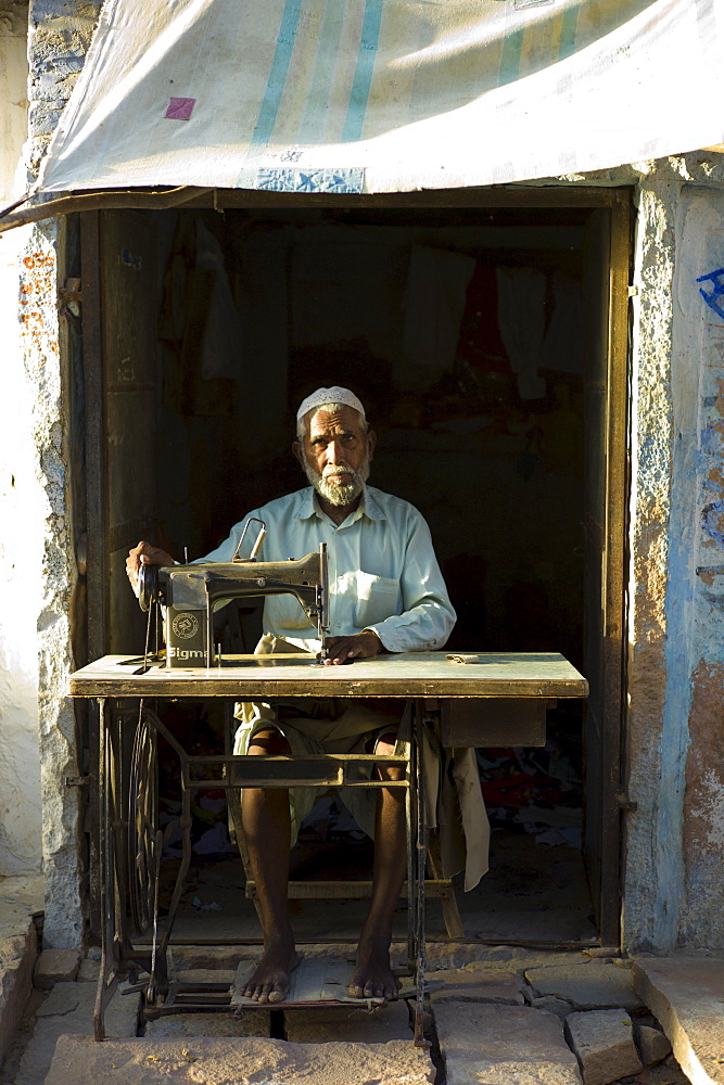 Indian man with sewing machine in village of Rohet in Rajasthan, Northern India