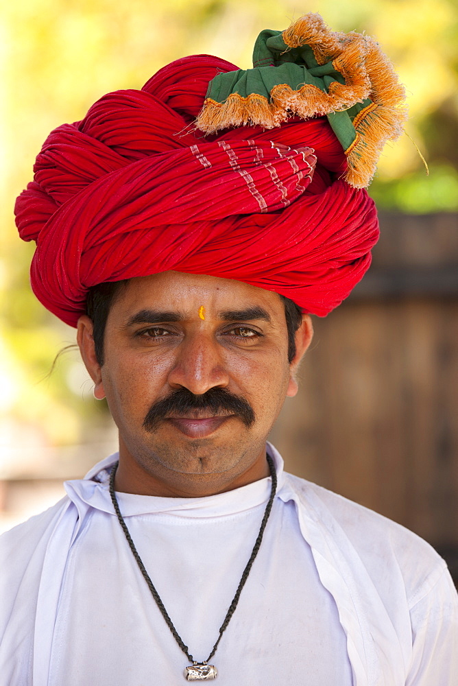 Young Indian man with traditional Rajasthani turban in Narlai village in Rajasthan, Northern India