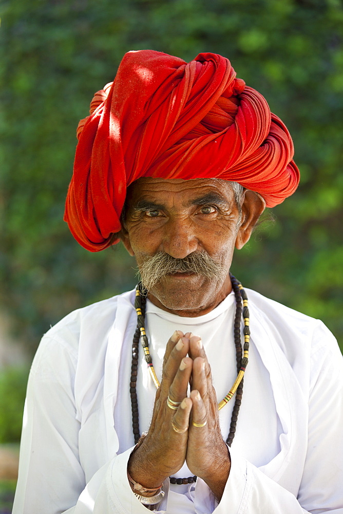 Traditional Namaste greeting from Indian man with traditional Rajasthani turban in village in Rajasthan, India