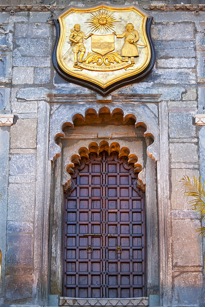 Ornate gateway and plaque of The City Palace Complex of the 76th Maharana of Mewar, Shriji Arvind Singh Mewar of Udaipur, Rajasthan, India