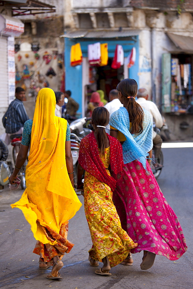 Indian family shopping in old town Udaipur, Rajasthan, Western India, Hindus and Muslims together.