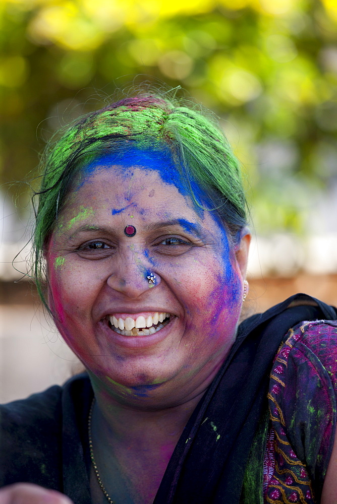 Indian woman celebrating annual Hindu Holi festival of colours with powder paints in Mumbai, formerly Bombay, Maharashtra, India