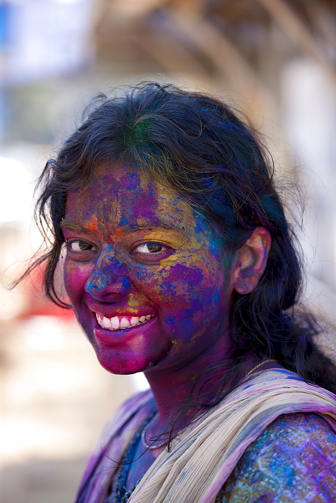 Indian woman celebrating annual Hindu Holi festival of colours with powder paints in Mumbai, formerly Bombay, Maharashtra, India