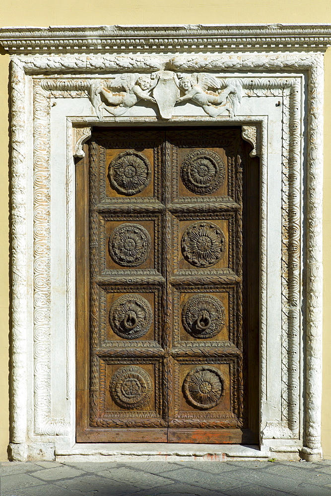 Ancient traditional doorway of Curia Arcivescoville in Piazalle Mons Giulio Arrigoni, in Lucca, Italy