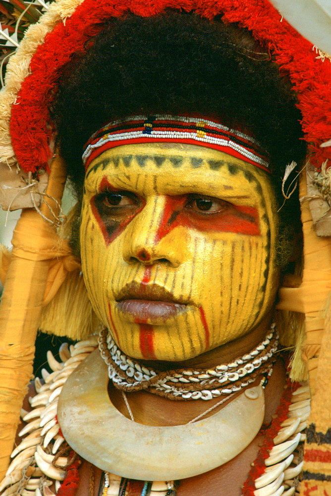 Woman in traditional costume with her face painted, Papua New Guinea