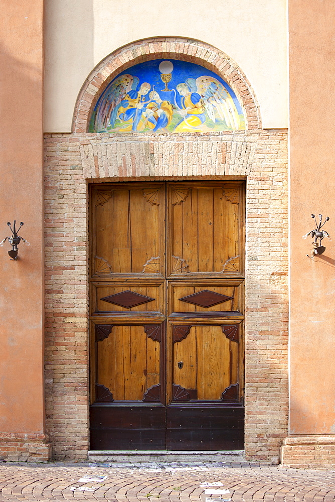 Traditional painted wall mural at church in Quartiere Ruga in Montalcino, Val D'Orcia,Tuscany, Italy