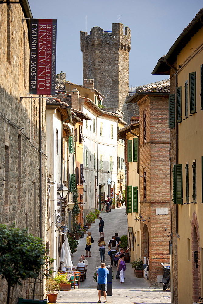 Visitors walking in Via Ricasoli in old hill town of Montalcino, Val D'Orcia,Tuscany, Italy