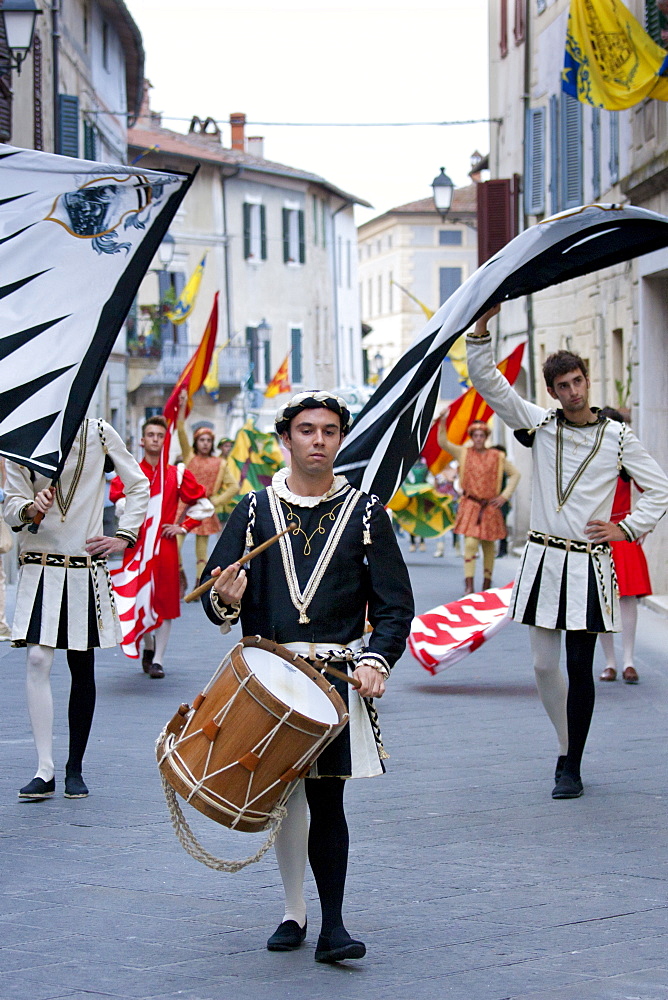 Contrada members in livery costumes for traditional parade in Asciano, inTuscany, Italy