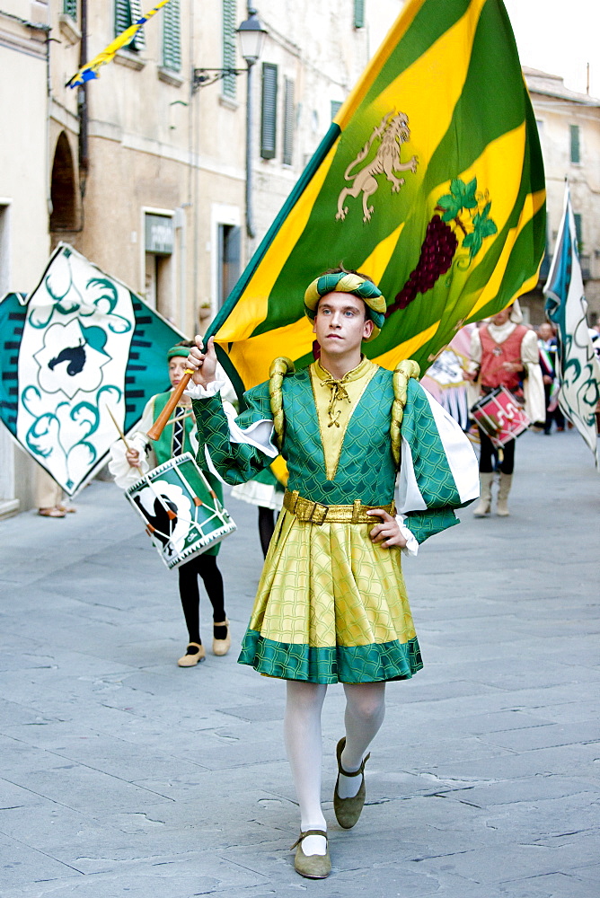 Contrada members in livery costumes for traditional parade in Asciano, inTuscany, Italy