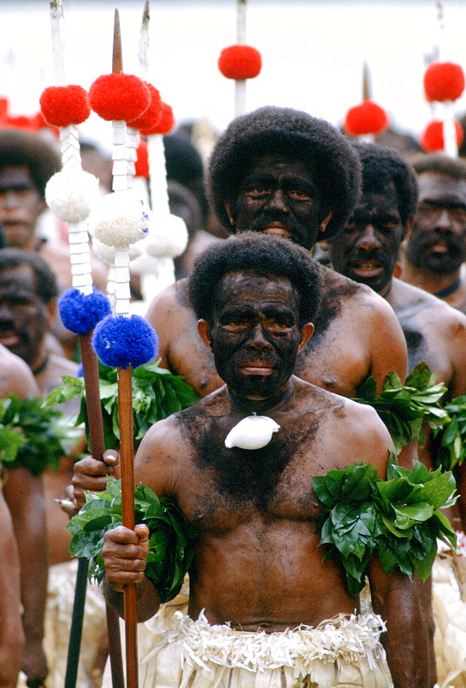 Fijian warriors faces painted black in the traditional manner while attending a tribal gathering in Fiji, South Pacific