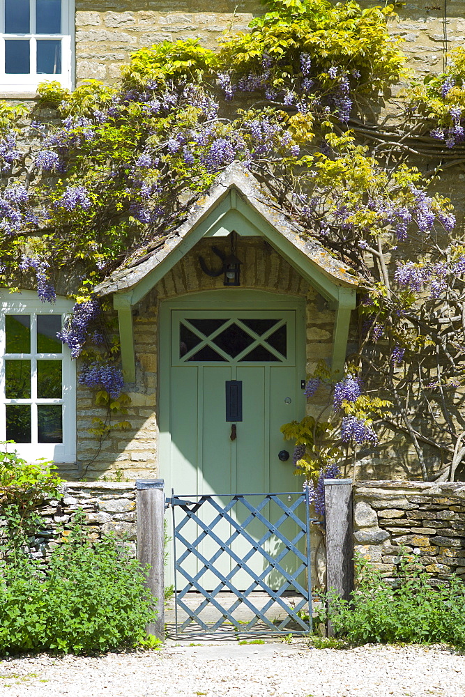 Traditional Cotswold stone wysteria-clad cottage in the quaint village of Eastleach Turville in the Cotswolds, Gloucestershire, UK