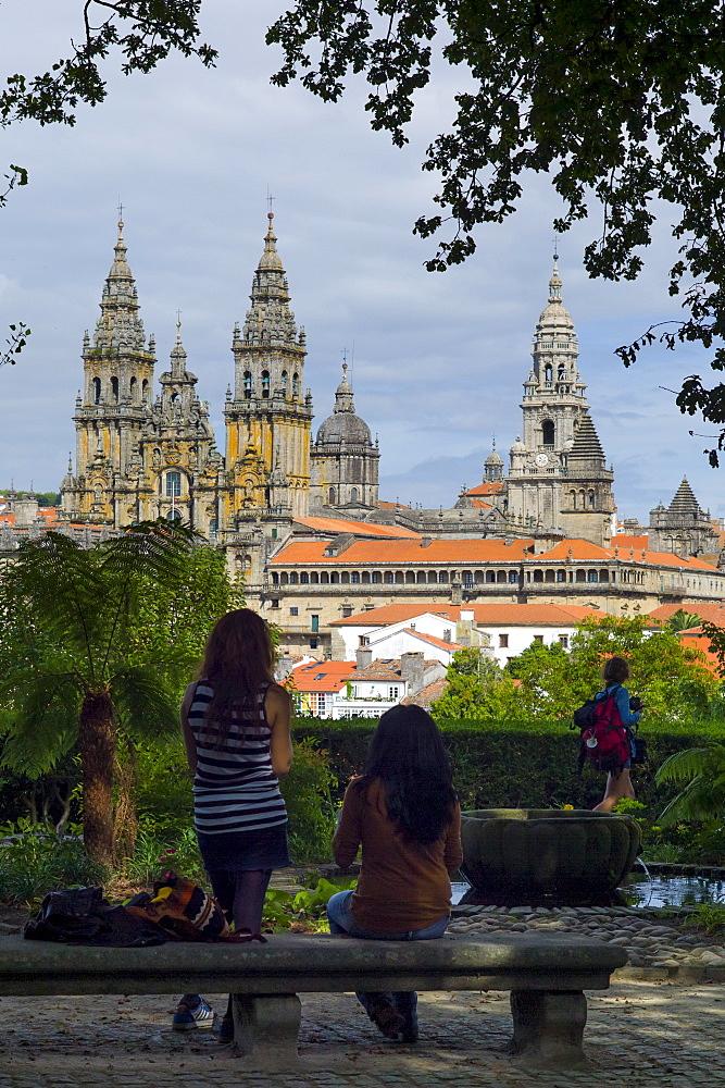 Young tourists in Alameda Park view Roman Catholic cathedral, Catedral de Santiago de Compostela, cityscape, Galicia, Spain