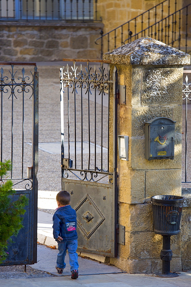 Young boy arrives at school in traditional Basque town of Laguardia in Rioja-Alavesa area of Spain