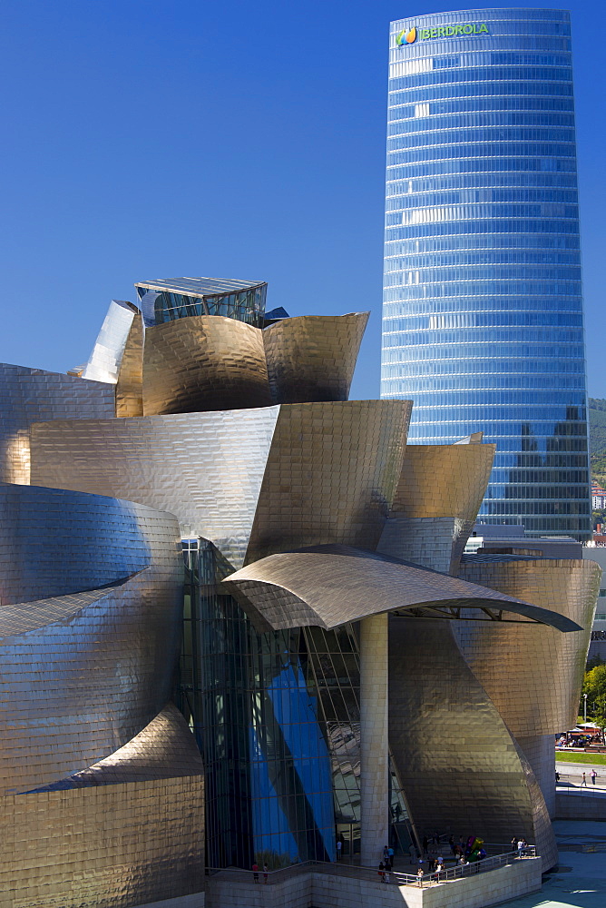 Frank Gehry's Guggenheim Museum futuristic architectural design in titanium and glass and Iberdrola Tower at Bilbao, Spain