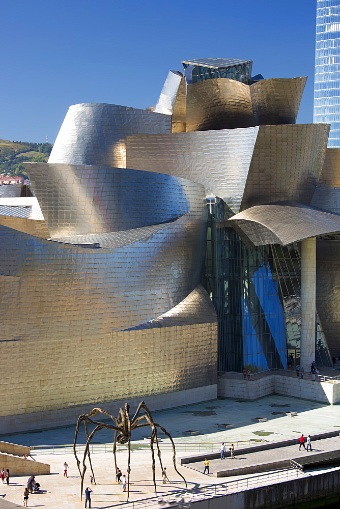 Architect Frank Gehry's Guggenheim Museum futuristic architectural design in titanium and glass, giant spider sculpture 'Maman' in Bilbao, Spain