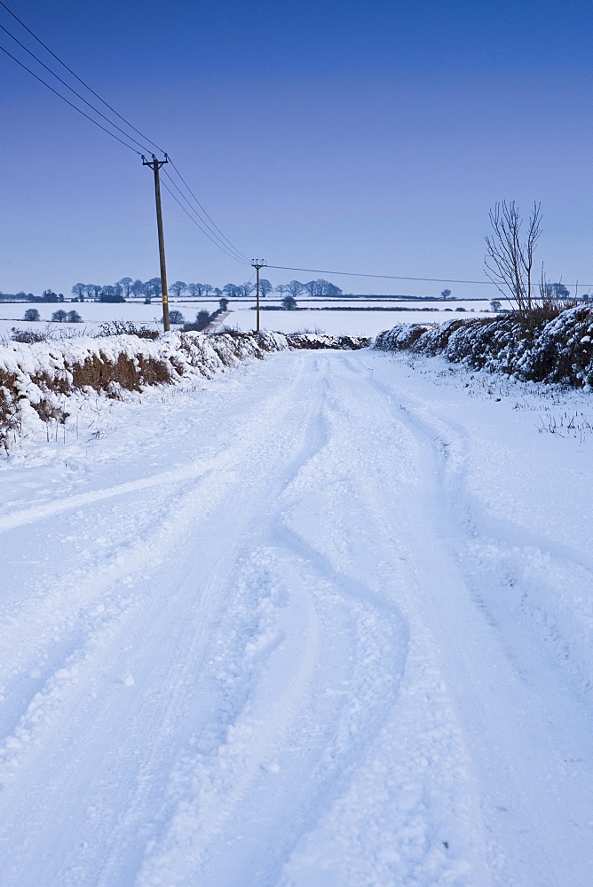 Country lane in deep snow in The Cotswolds, Swinbrook, Oxfordshire, United Kingdom