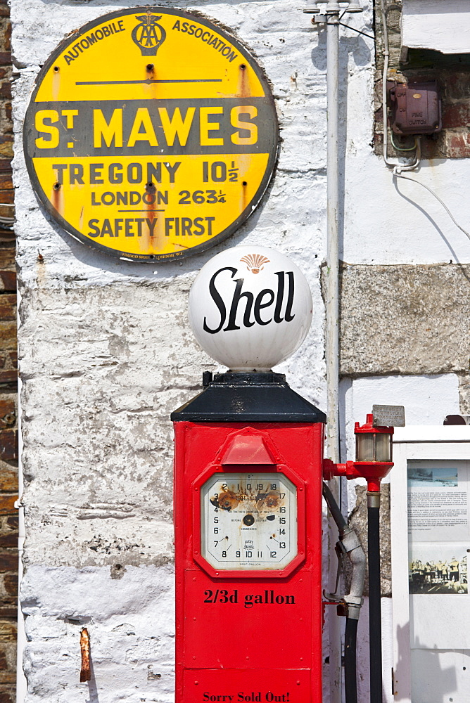 Vintage Shell petrol pump and Automobile Association AA sign ephemera at St Mawes tourist attraction, Cornwall, England, UK