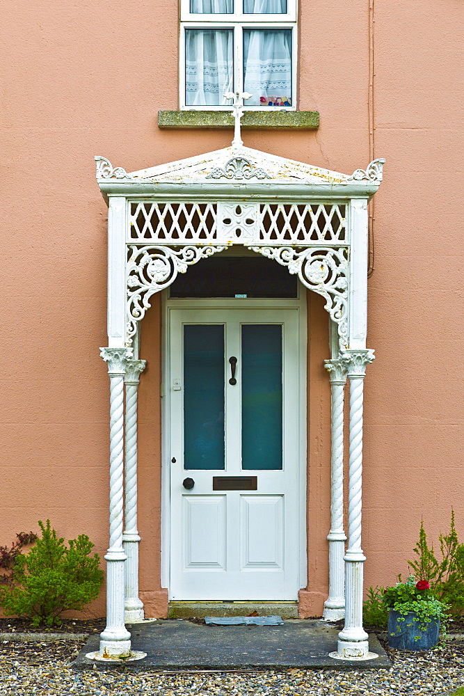 Fretwork ironwork canopy porch on Georgian house on Ocean Drive in Rosslare, Ireland