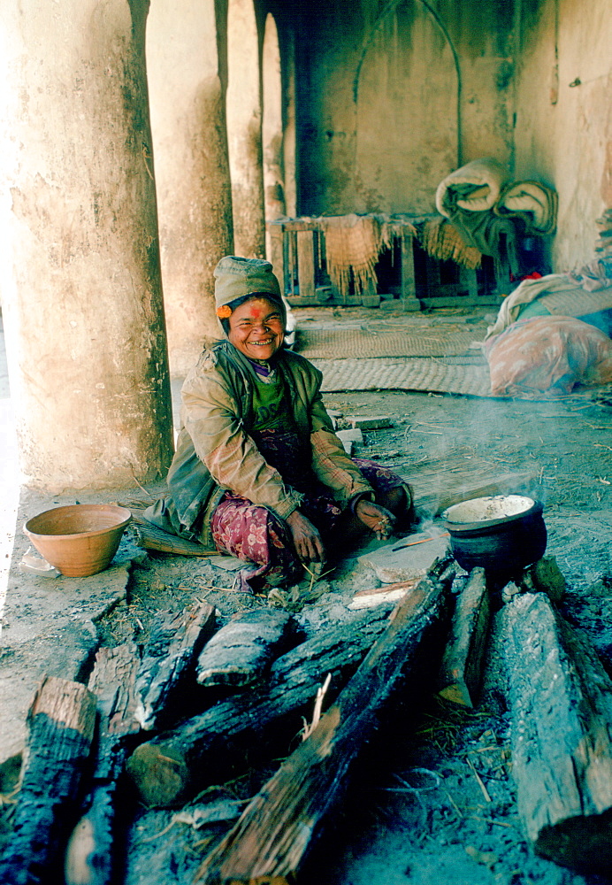 Holy woman sitting on the ground at the Pashupatinath Temple, Kathmandu Valley, Nepal