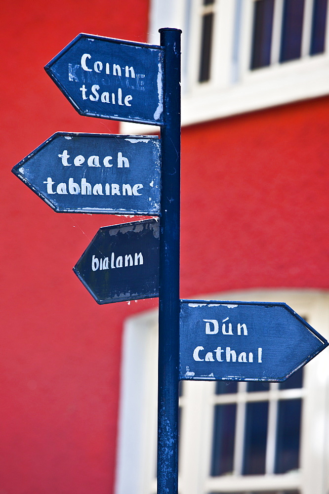 Gaelic signpost to Kinsale and other destinations in Timoleague, County Cork, Ireland