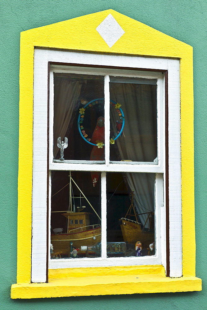 Aquamarine colour wall and yellow window border in Kinsale, County Cork, Ireland