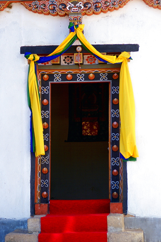 Traditional decorated doorway of the Institute of Traditional Medicine with a modern day fluorescent light above it, Paro, Bhutan.