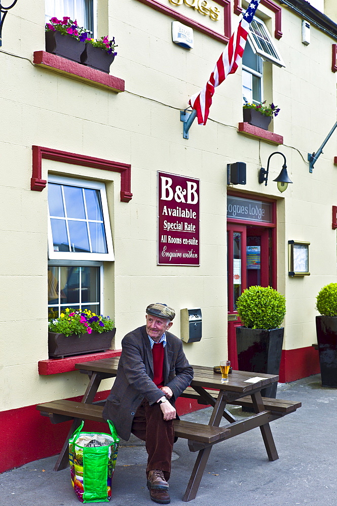 Elderly Irish man has a beer and a rest after shopping at farmers' market, Ballyvaughan, County Clare, West of Ireland