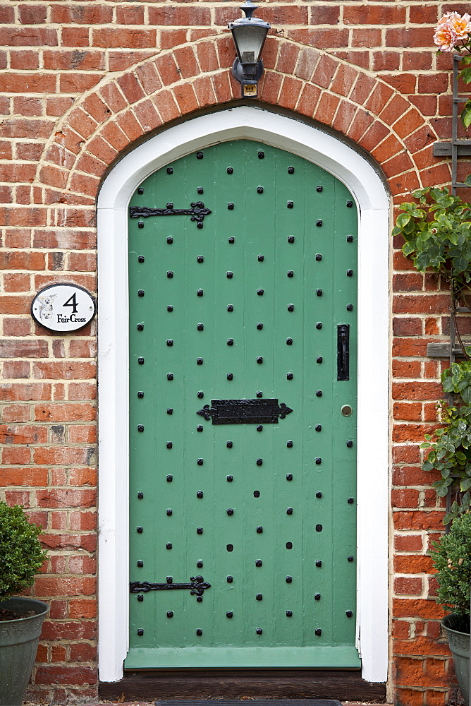 Studded arched door by Stratfield Saye House, Hampshire, United Kingdom