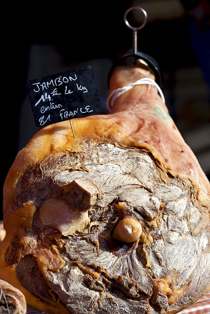 Leg of cured ham, Jambon, on sale at food market at La Reole in Bordeaux region of France