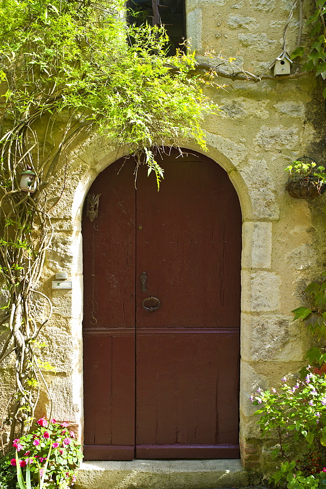 Traditional French doorway in quaint town of Castelmoron d'Albret in Bordeaux region, Gironde, France