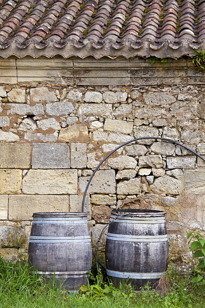 Traditional old wine barrels at a wine chai near St Emilion, Bordeaux, France